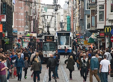 Amsterdam's Leidsestraat shows how gauntlet track allows bidrectional light rail operation in a very narrow alignment, even with very close headways. Also remarkable is how smoothly, efficiently, peacefully, and safely the tram line blends in with, complements, and serves all the pedestrians who walk alongside, behind, and even in front of the trams.