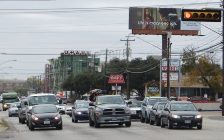 North Lamar traffic (several blocks north of the Triangle). Guadalupe-Lamar travel corridor carries heaviest traffic flow of any local Central Austin arterial, serves residential concentration ranking among highest density in Texas, serves 31% of all Austin jobs — yet corridor was "dismembered" by Project Connect and excluded from "Central Corridor" study! Photo: L. Henry.