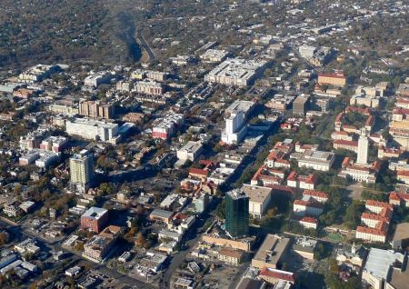 Aerial view (looking north) of "Drag" section of Guadalupe St. (wide arterial running from bottom middle of photo to upper right). Western edge of UT campus is at far right, and extremely dense West Campus neighborhood occupies middle left of photo. In upper right corner, Guadalupe jogs northwest, then north again; main travel corridor eventually merges with North Lamar further north. Photo: Romil, posted in forum.skyscraperpage.com.