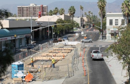 Construction for dedicated bus lanes, rarely shown by "BRT" promoters, is very similar to that for LRT, as this example from San Bernardino demonstrates. Yet effective capacity, ridership attraction, cost-effectiveness, TOD, and other benefits typically fall short of what LRT typically achieves. Photo: Omnitrans.org.