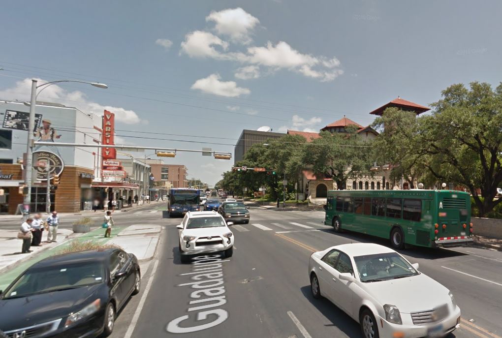 Busy section of Austin's Drag, Guadalupe St. at W. 24th St. Official city planning by CTR has proposed curbside transit lanes, with buses running on outside lanes as seen in this photo. (Screenshot from Google Streetview.)
