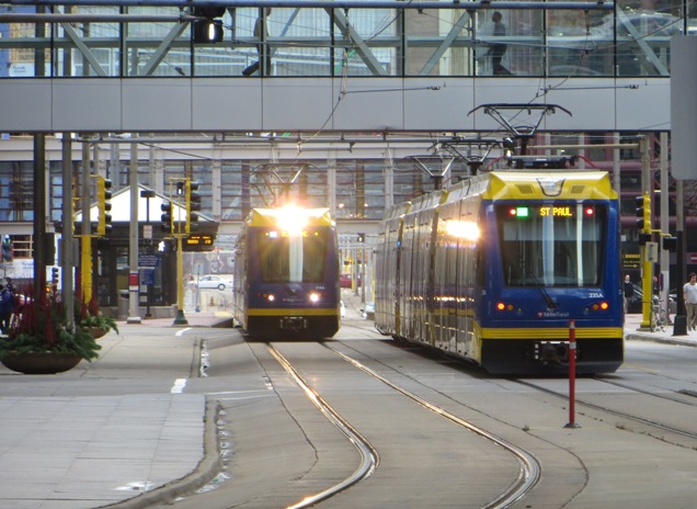 Two light rail trains pass on 5th St., a major downtown east-west thoroughfare with dedicated lanes for light rail. Photo: L. Henry.
