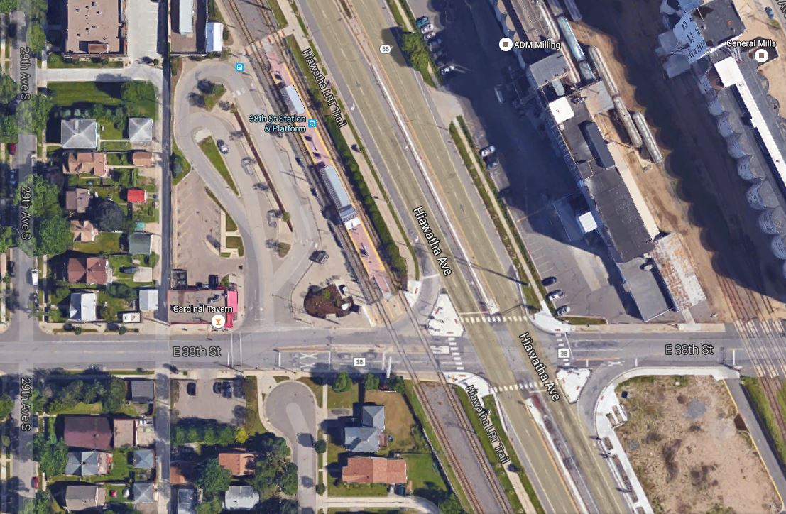 In this Google Earth view, Hiawatha Ave., with the LRT line paralleling it on its western edge, runs diagonally north-south through the center of the photo. The 38th St. LRT station can also be seen, while E. 38th St. crosses both LRT line and Hiawatha Ave. east-west, in the bottom third of the graphic. Note that Hiawatha and the LRT line intersect E. 38th St. at about a 60-degree angle, somewhat similarly to Airport Blvd and N. Lamar and the MetroRail Red Line in Austin. Photo: ARN, from Google Earth.