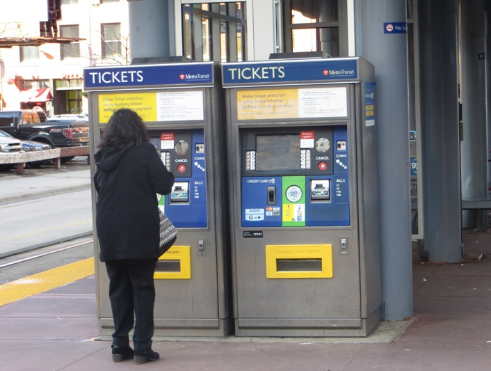 Passenger purchases ticket from TVM at downtown station. Photo: L. Henry.